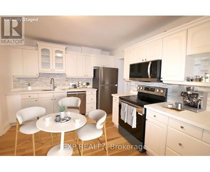 A kitchen with white cabinets and a black stove top oven.