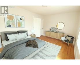 A bedroom with a large bed and a chair.