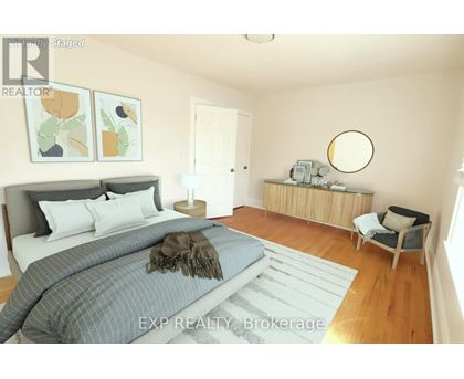 A bedroom with a large bed and a chair.