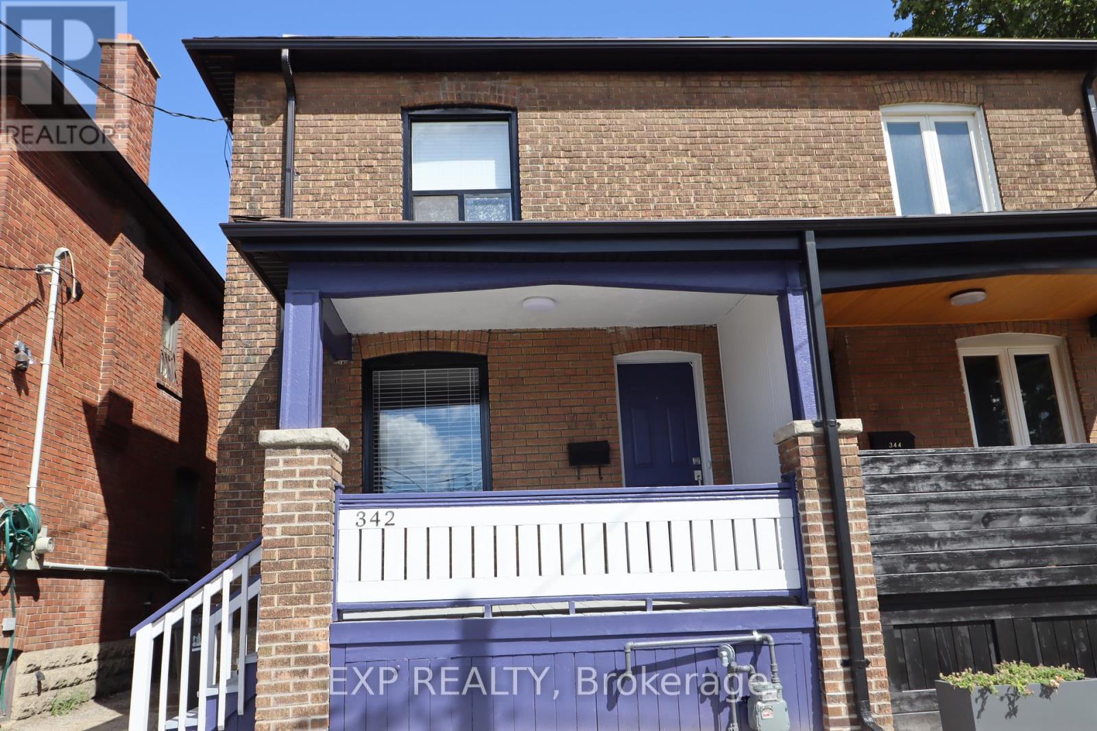 A house with a blue door and a balcony.