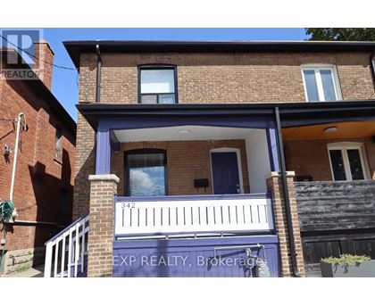 A house with a blue door and a balcony.