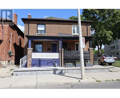 A house with a blue front door and a no parking sign on the street.