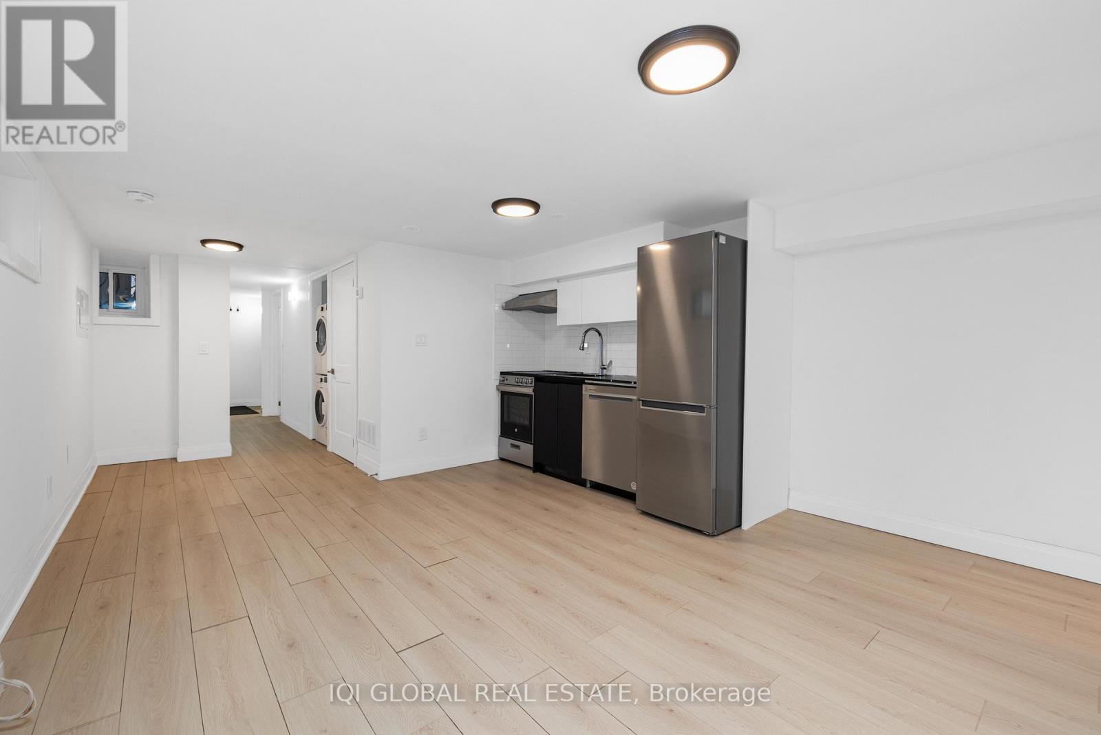 A kitchen area with a refrigerator, oven, and microwave.