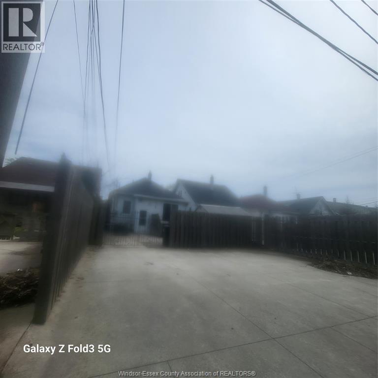 A realtor's photo of a residential area with houses and a fence.