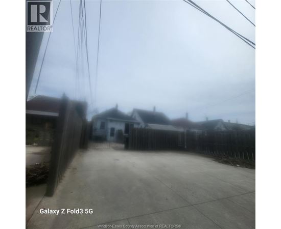 A realtor's photo of a residential area with houses and a fence.