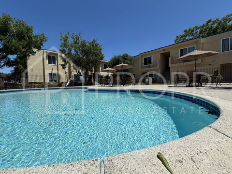A swimming pool in front of a residential building.