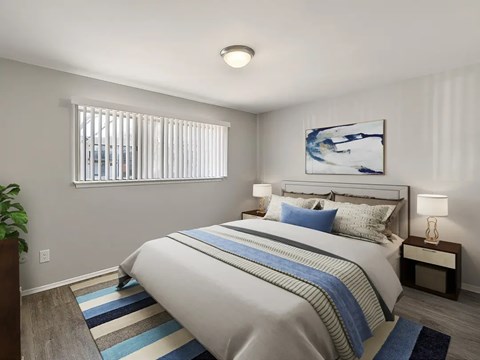 A bedroom with a large bed and a painting on the wall.
