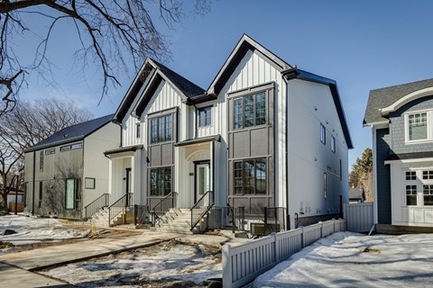 A modern house with a white and black exterior.