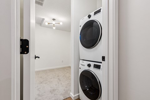 A white washing machine is in a small room.