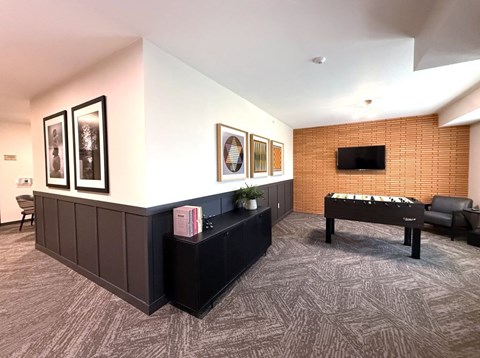 A room with a pool table and a couch.