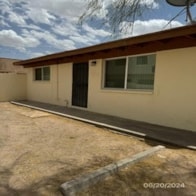 A house with a brown roof and a black door.