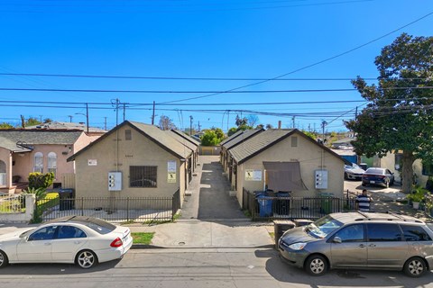 A residential area with houses and parked cars.