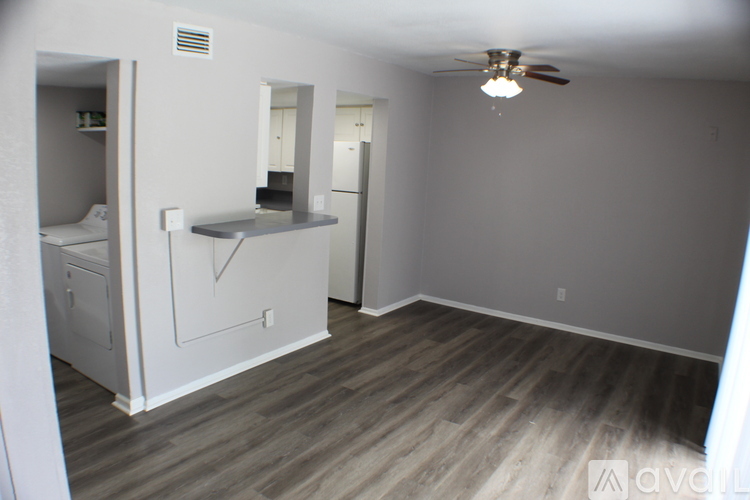 A room with a ceiling fan and a counter with a sink.
