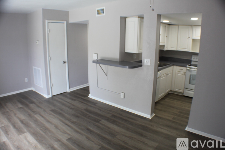 A kitchen area with a counter and cabinets.