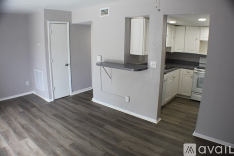 A kitchen area with a counter and cabinets.