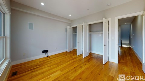 A room with wooden floors and white walls.