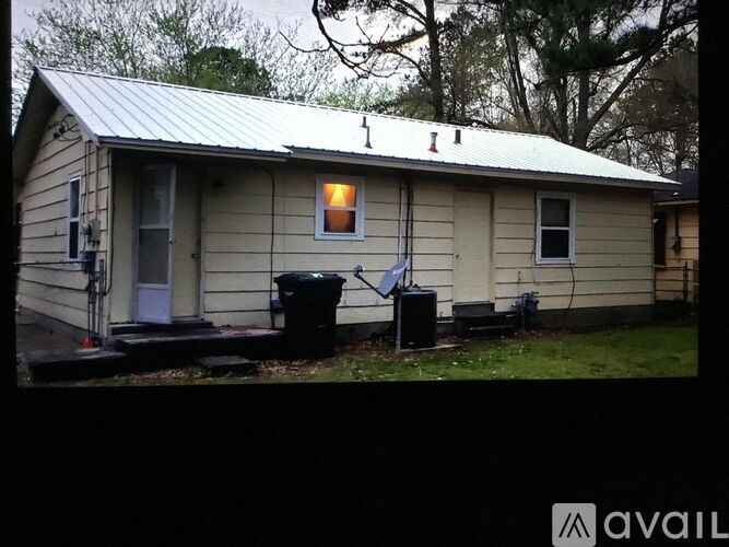 A house with a metal roof and a small porch.