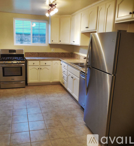 A kitchen with a stainless steel refrigerator, oven, and other appliances.