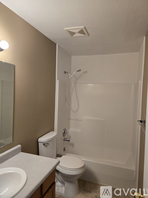 A room with a window and a carpeted floor.