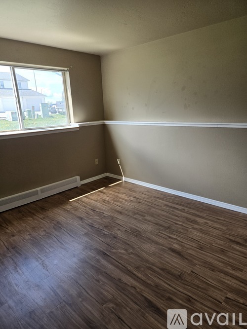 A room with a window and a sign that says "Bedrooms are spacious".