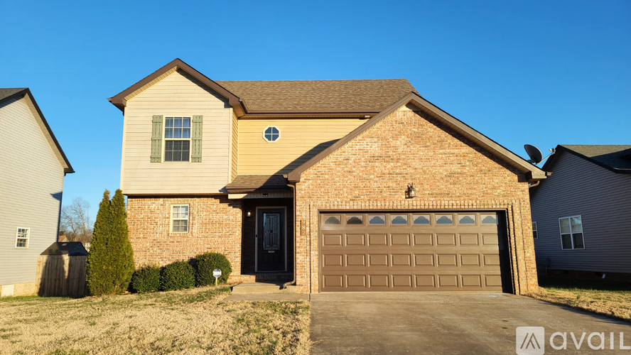 A house with a garage door and a window is for sale.