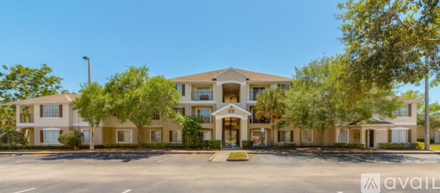 A large, multi-story building with a parking lot in front.