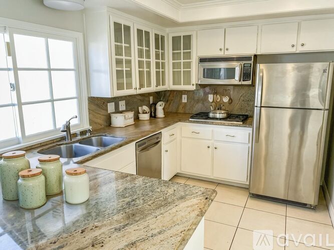 A kitchen with granite countertops and stainless steel appliances.