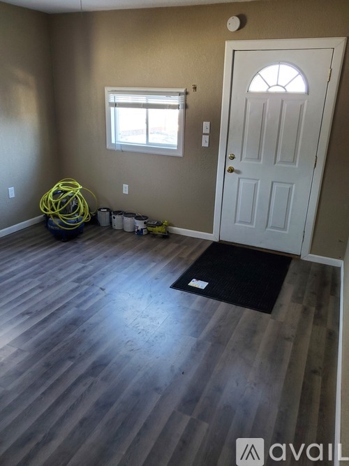 A room with a white door and a window with a white frame.