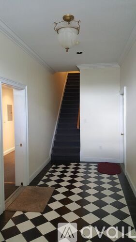 A hallway with a black and white checkered floor.
