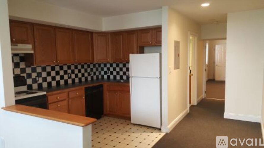 A kitchen with a checkered black and white floor.