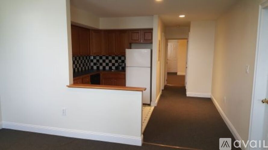A room with a checkered black and white tile backsplash.
