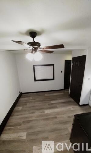 A room with a black door and a white wall.