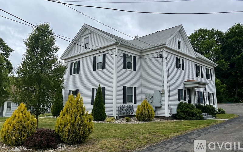 A two-story house with a grey exterior and a white trim.