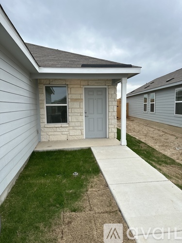 A small house with a grey door and a grey window.
