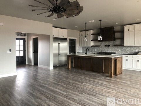 A spacious kitchen with a large island and modern appliances.