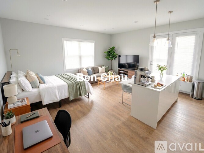 A modern bedroom with a bed, desk, and chair.