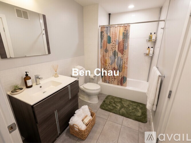 A bathroom with a sink, toilet, and shower area.