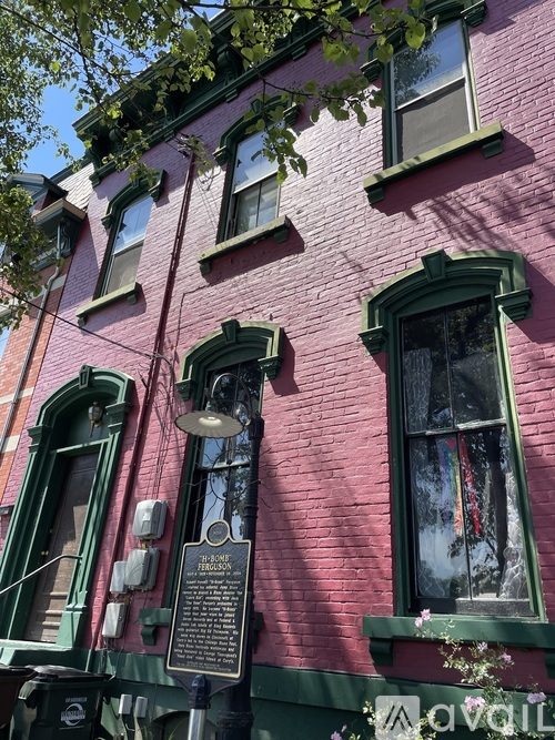 A red building with a plaque on the front.