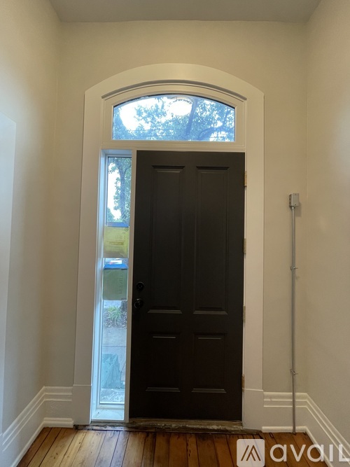 A black door with a window above it.