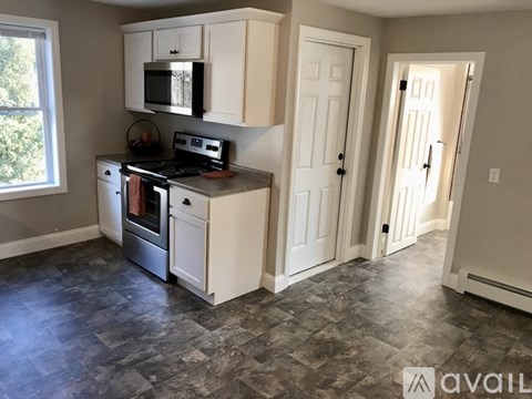 A kitchen with a stove top oven and microwave.