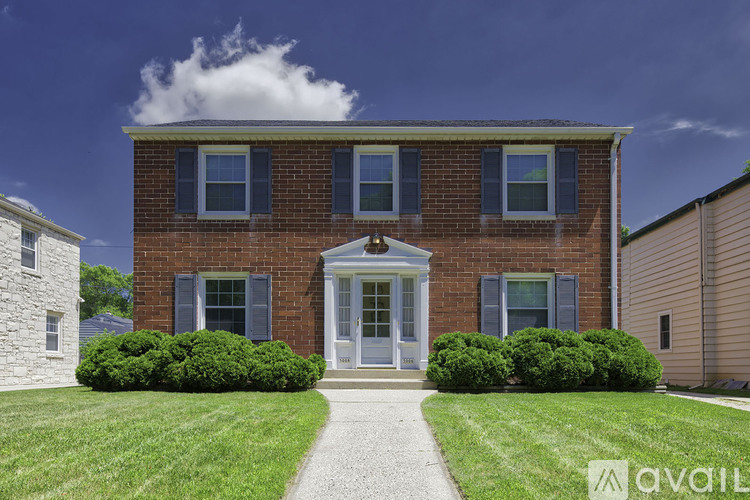 A brick house with a white door and windows.