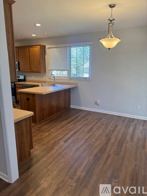 A kitchen with wooden cabinets and a countertop.