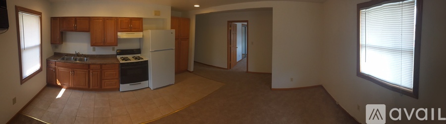 A kitchen with wooden cabinets and a white refrigerator.