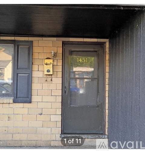 A black door with a number 1451 on it.
