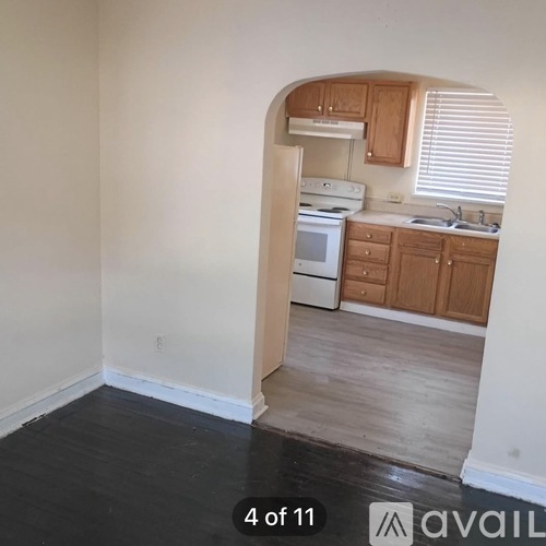 A kitchen with wooden cabinets and a white fridge.