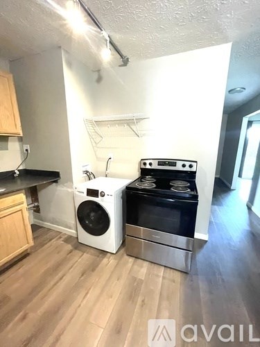 A kitchen with a stove top oven and a dishwasher.