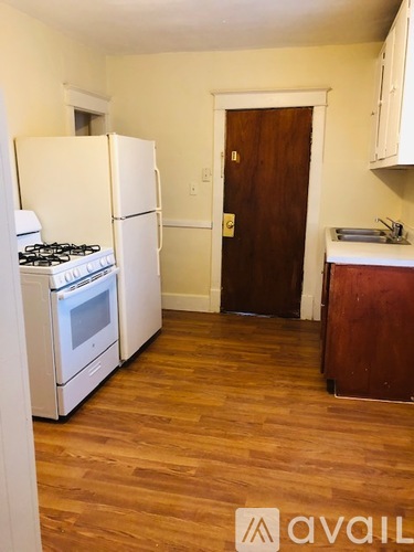 A kitchen with a white fridge and stove.