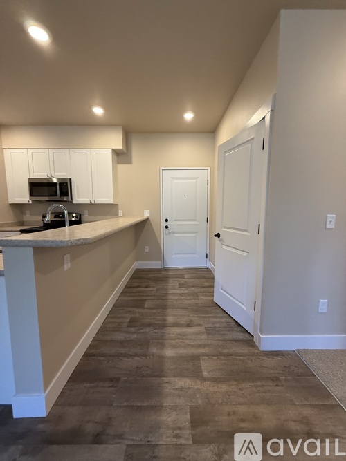 A kitchen with a counter and a microwave.