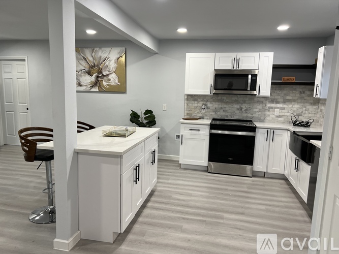 A modern kitchen with white cabinets and a center island.
