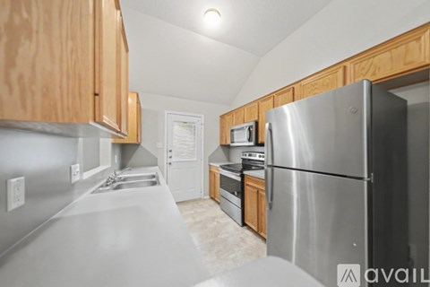 A kitchen with wooden cabinets and stainless steel appliances.